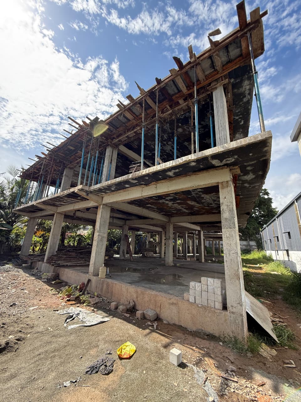 A civil engineer inspecting a construction site with blueprints